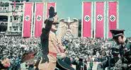 Adolf Hitler saudando seus membros, cercado por símbolos nazistas - Getty Images