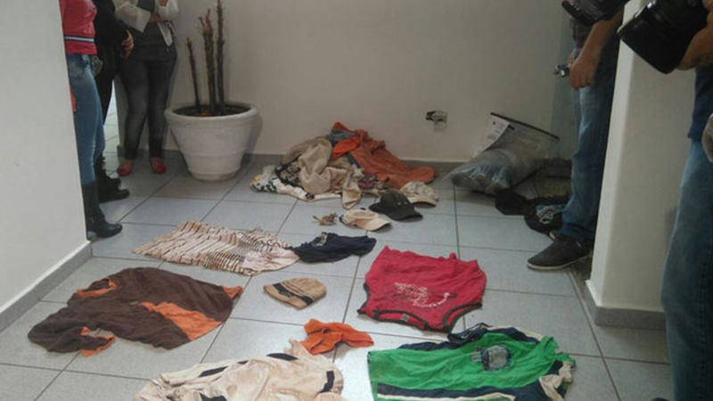 Pessoas observam roupas encontradas na casa do pintor - Divulgação / G1