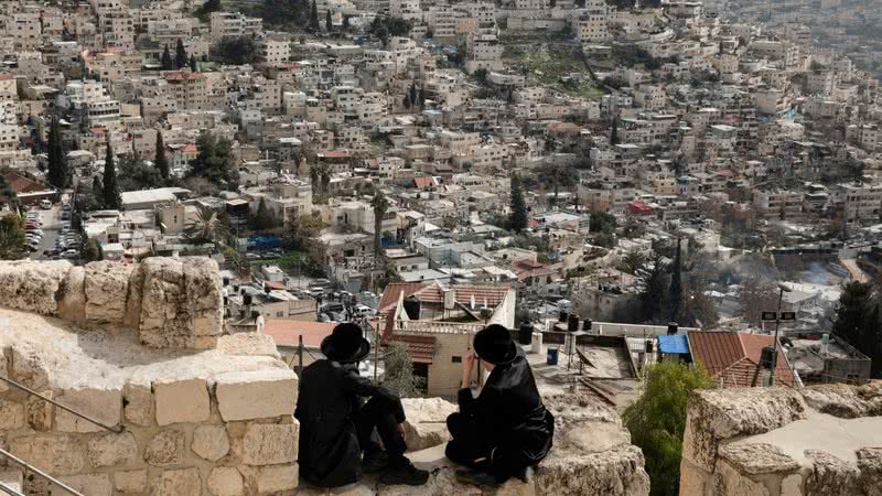 Imagem ilustrativa de homens observando um bairro localizado em Jerusalém Oriental - Getty Images