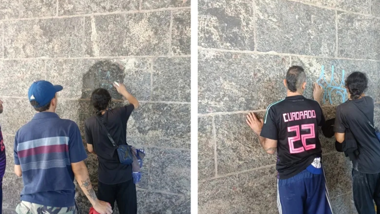 Colombianos presos por picharem muro no Cristo Redentor voltam para fazer limpeza