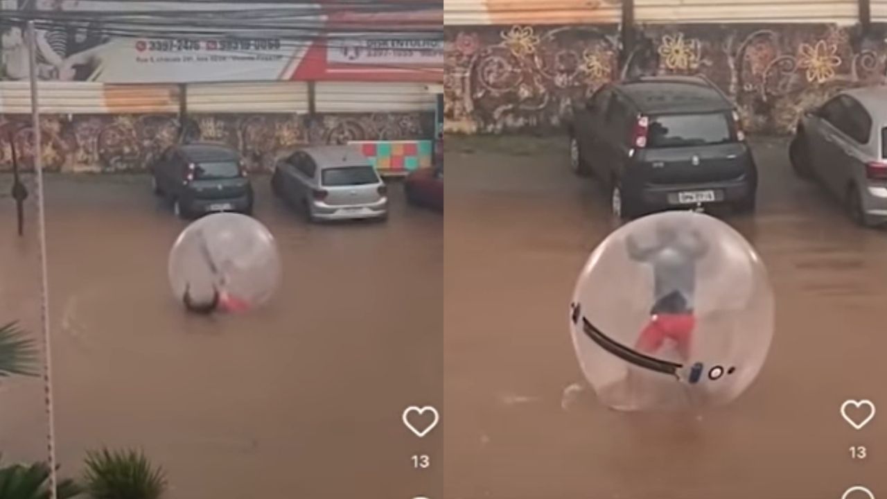 No DF, homem usa bolha inflável para se transportar em rua alagada